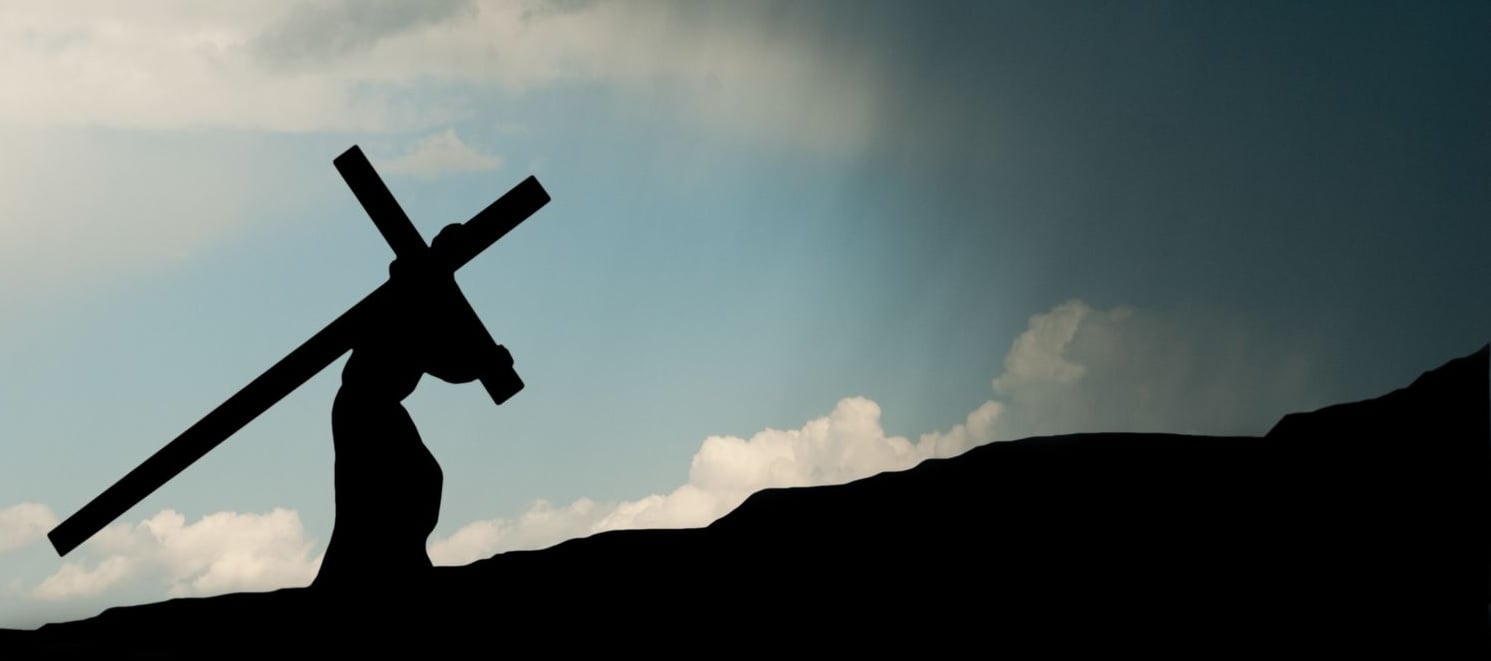 Jesus carrying the cross in silhouette